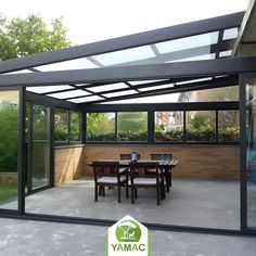 an outdoor dining area with glass walls and tables