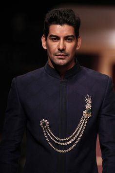 A model at the IIJW 2013 wearing a double pin brooch from the Amer collection by Birdhichand Ghanshyamdas Indian Groom Dress, Indian Groom Wear, Sherwani Groom, Groom Accessories, Men's Ethnic Wear, Wedding Outfit Men, Indian Men Fashion, Wedding Sherwani