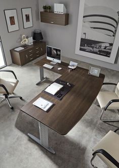 an office desk with two chairs and a computer on it