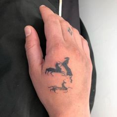 a person's hand with a tattoo on it