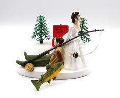 a figurine of a bride and groom with fishing gear on a white background