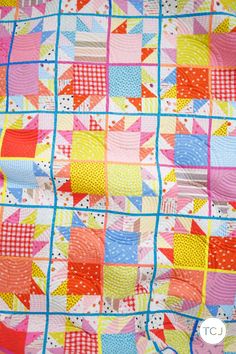 a colorful quilt with squares and dots on it