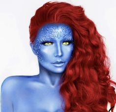 a woman with long red hair and blue makeup