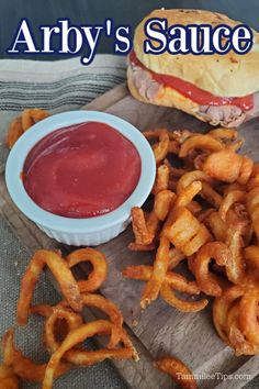 an image of a sandwich and onion rings on a cutting board with the words arby's sauce