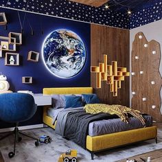 a bedroom decorated in blue and yellow with the earth on the wall