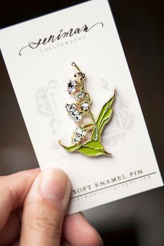 "A white Lily of the Valley soft enamel pin for your daily botanical pick me up. Perfect addition to your flower enamel pin collection and to personalize your bags, jeans, jackets and pouches! Size 1.23\"x1.75\" Gold plating with butterfly clip" White Lily Of The Valley, Enamel Pin Collection, Floral Pins, White Lily, Pretty Pins, Soft Enamel Pins, White Lilies, Cool Pins, Soft Enamel