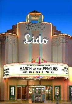 an old movie theater with the marquee lit up