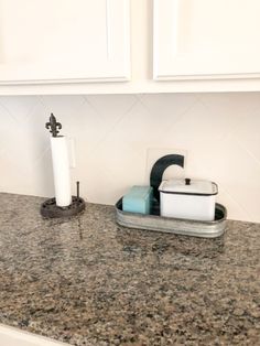 a bathroom counter with soap and toothbrushes on it