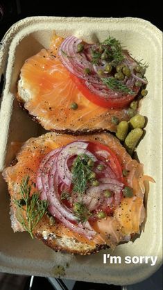 two pieces of bread topped with salmon and vegetables