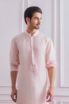 Editor's Note Featuring A Bespoke Powder Pink Nehru Jacket With Intricate Hand Embroidery, Metal Buttons And Minimal Detalis. Perfect For Any Indoor Or Outdoor Occasion. This Comes With A Tonal Plain Powder Pink Satin Linen Kurta And Ivory Churidaar. Color: Pink Fabric: Cotton & Silk Care: Dry Clean Only About the Designer Ankit V Kapoor is a clothing brand that amalgamates traditional Indian handicrafts and bespoke tailoring. Inspired by the heritage of India and unified with revolutionary thou Pink Indian Outfit Men, Pastel Men’s Kurta, Baby Pink Kurta For Men, Light Pink Kurta For Men, Pink Kurta For Men, Pink Indian Outfit, Nehru Jacket With Kurta, Pastel Color Shirts, Kurta Designs Men's