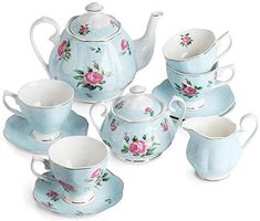 a blue tea set with pink roses on it