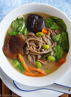 a white bowl filled with soup and vegetables