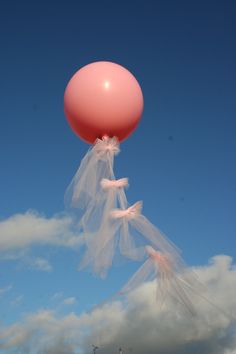 a large pink balloon floating in the air