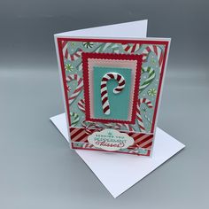 a christmas card with a candy cane on it