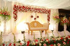 a decorated stage with white and red flowers