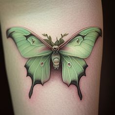 a green butterfly tattoo on the thigh