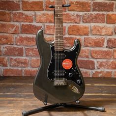 an electric guitar sitting on top of a wooden table