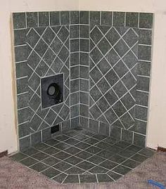 a bathroom with a toilet in the corner and tile on the floor next to it