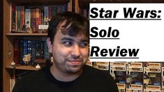 a man standing in front of a bookshelf with the words star wars solo review on it