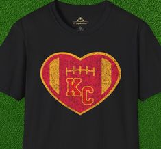 Enhance your fan gear collection with our Vintage KC Heart Red & Gold Kansas City Chiefs inspired t-shirt. Classic colors help you show your team spirit, and the distressed graphics give this shirt a vintage feel. It's ideal for pairing with your favorite jeans or leggings, or layering under a jacket for those colder game days. Plus, its high quality tubular construction means it will hold up, season after season, as you support your team through every touchdown and tackle. Fan Apparel Sublimation Design T-shirt, Fan Apparel T-shirt For Football Season, Team-colored Screen Print T-shirt For Fans, Graphic Print T-shirt For Football Season Fan Events, Team-colored Sublimation Design For Fan Merchandise, Baseball Season Fan Apparel With Sublimation Design, Football Season Fan Apparel T-shirt, Crew Neck Sublimation Design With Team Logo For Fans, Retro Team Name T-shirt For Fans