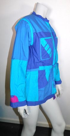 "This great 80s jacket is like getting two jackets in one! It's blue on one side and purple and pink on the other. Both sides feature a tie belt. The jacket is an open front style. It has patch pockets on both sides. There are tabs in the sleeves so you can roll them up and show off the contrast color of the other side of the jacket. So basically you get about 4 looks in one-what a deal! Jacket has no designer labels that I could find but there is a small size tag sewn to one pocket that says M. 90s Patchwork Blue Outerwear, 90s Blue Patchwork Outerwear, 90s Style Blue Patchwork Outerwear, Designer Labels, 80s Jacket, Types Of Hats, Sewing Tags, Pink M, Cloche Hat