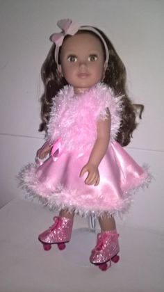 the doll is wearing a pink dress and shoes