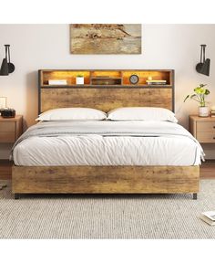 a bed that is made up with white sheets and wooden headboard, along with two nightstands