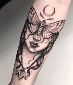 a woman's arm with a butterfly tattoo on it