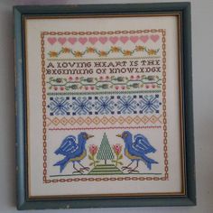 a cross stitch pattern with two blue birds on it and the words, a loving heart is