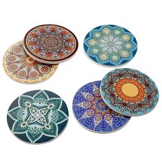 four plates with designs on them sitting next to each other