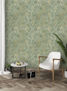 a chair and table in front of a wallpapered room with green leaves on it