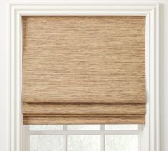 a tan roman blind in front of a window