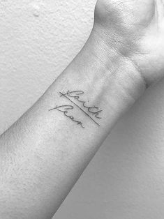 a woman's arm with the word love written on it and an arrow tattoo