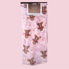 a pink christmas stocking with gingerbreads and snowflakes on the bottom