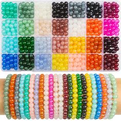 rainbow colored beads are arranged in rows on a wooden stick, with the colors shown below them