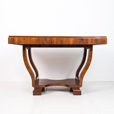 a wooden table sitting on top of a white floor