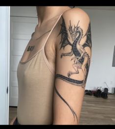 a woman with a dragon tattoo on her arm