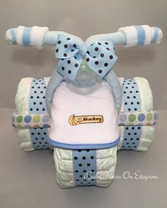 a blue and white baby bib with polka dots on it, attached to a stuffed animal