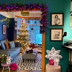 the living room is decorated for christmas with purple and green decorations on the walls,