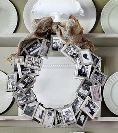 a wreath made out of photos is sitting on a table with plates and napkins