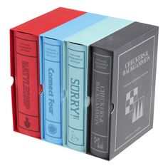 three different colored books in a box