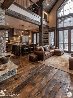 a living room filled with lots of furniture next to a stone fireplace and large windows