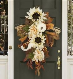 a front door decorated with flowers and leaves