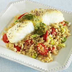 a white plate topped with fish and rice