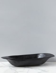 a black bowl sitting on top of a white counter