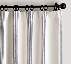 an image of a curtain hanging on the side of a window with curtains pulled down