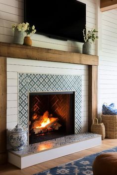 a fireplace with a television above it in a living room