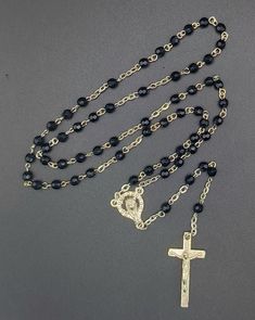 Introducing our striking Black Rosary, a bold and profound expression of faith and devotion. Crafted with meticulous attention to detail, this rosary features deep black beads that symbolize strength, resilience, and spiritual depth. Each bead is carefully polished to a smooth finish, providing a tactile and meditative experience during your prayers. The Black Rosary is designed with a durable yet elegant silver chain that enhances both its functionality and style. At its center is a beautifully Black Rosary Aesthetic, Adjustable Black Spiritual Rosary, Adjustable Black Rosary With Cross, Adjustable Silver Rosary With Black Beads, Black Beaded Cross-shaped Rosary, Pearl Rosary, Rosary Chain, Aesthetic Beauty, Prayer Beads