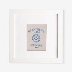 a white frame with a blue and white logo on the bottom that says st andrews golf club