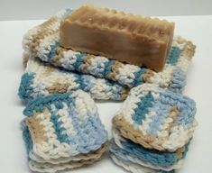 a soap bar sitting on top of crocheted coasters in blue and white